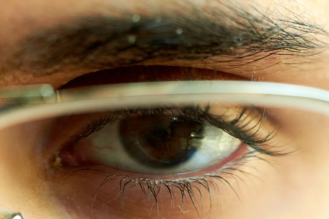 a close up of a person's eye looking through a magnifying glass
